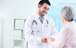 Confident doctor looking at his senior patient while speaking to her